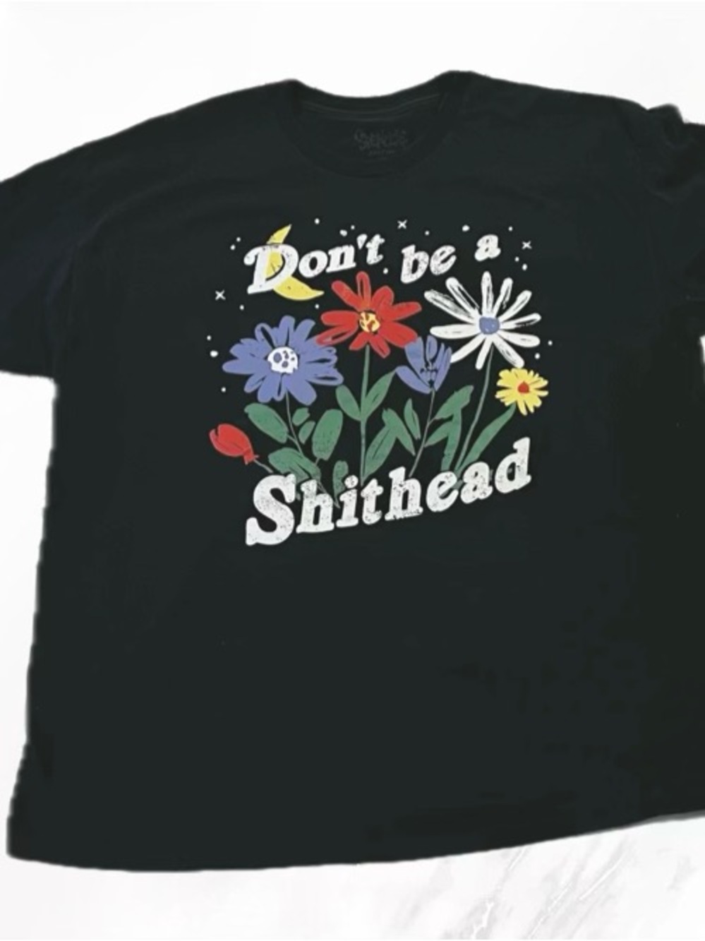 Spencer's Black Tee with Colorful Floral Graphic and Playful Text